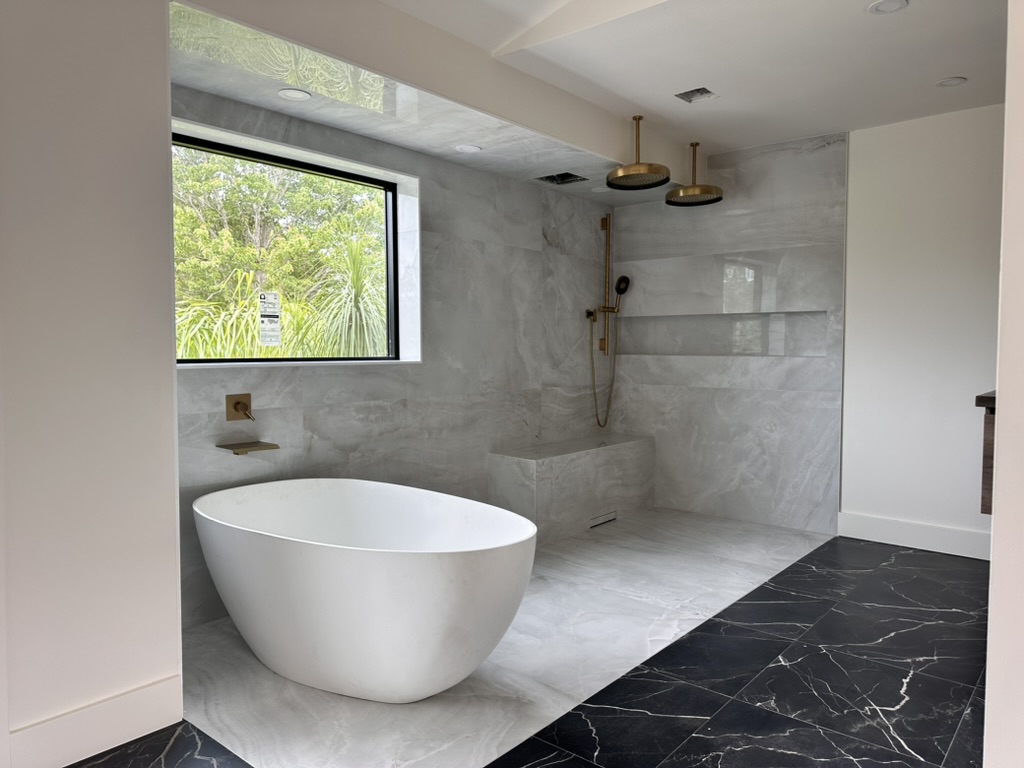 Longwood bathroom remodel with freestanding tub, walk-in shower, and marble tile